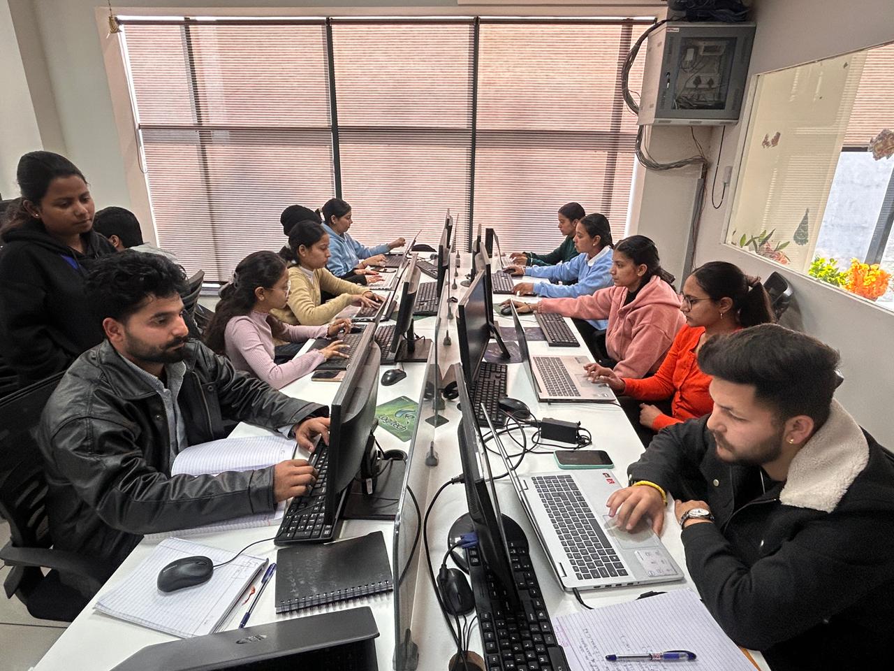 Students studying and practicing on computers during a focused Tuesday lab session at TechCadd Mohali institute